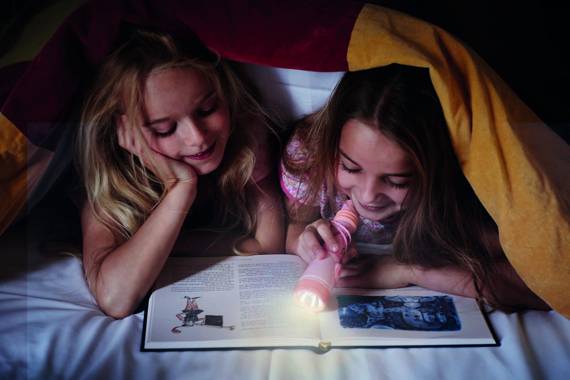 Children reading by torch light