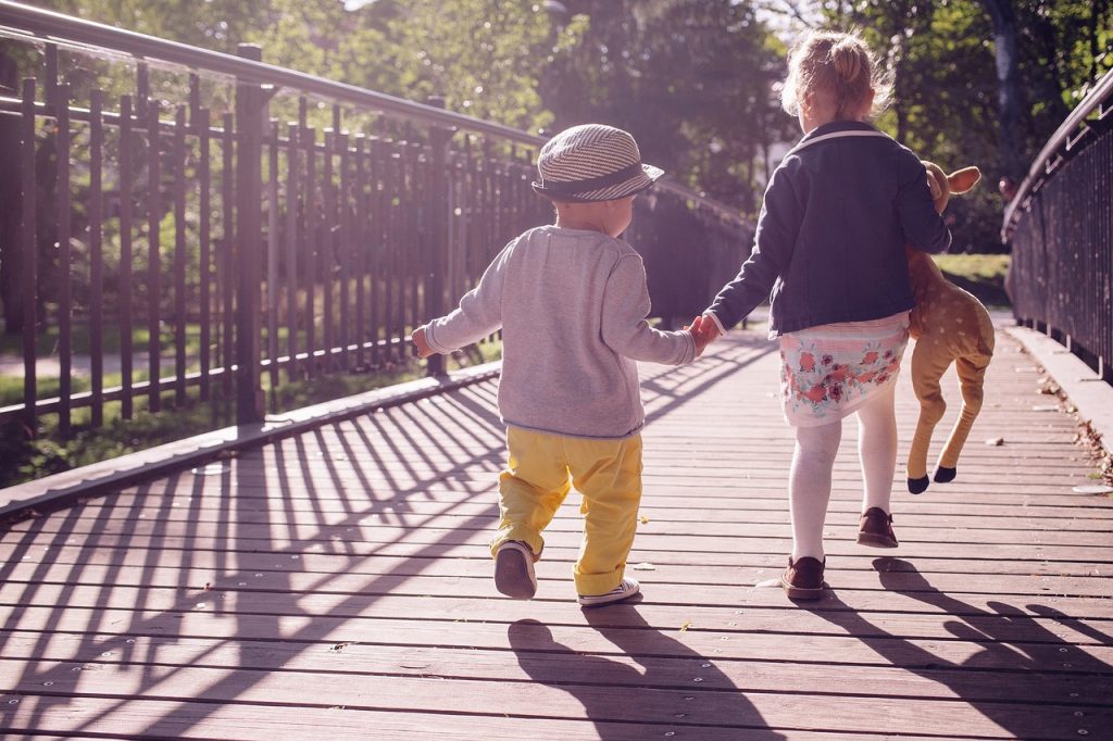 toddlers on a bridge on a sunny day